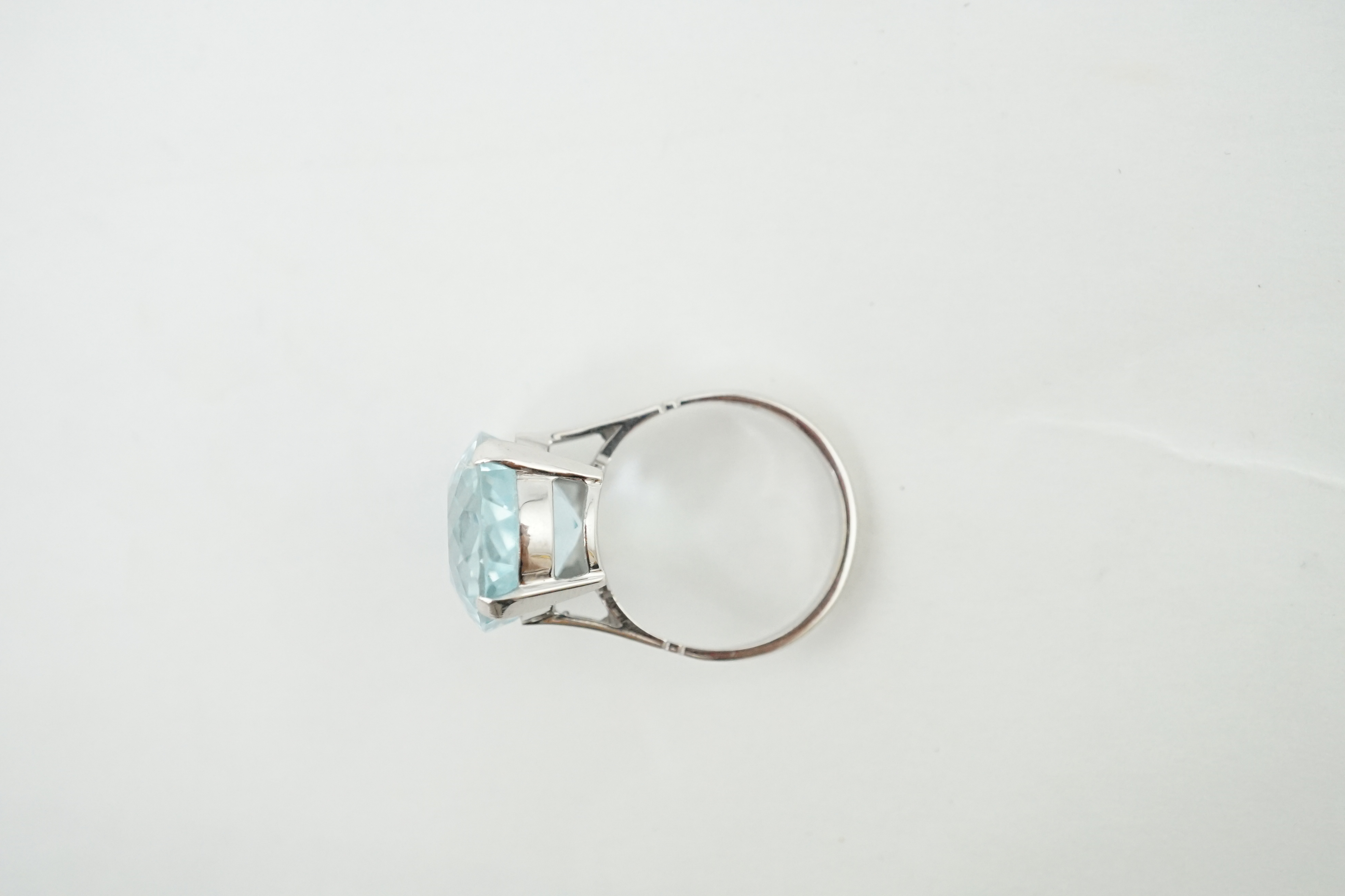 A mid 20th century 18ct white gold and single stone oval cut aquamarine set dress ring